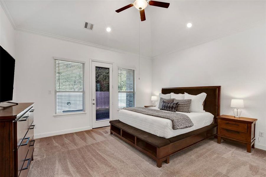 Primary bedroom with door leading to a private covered patio.