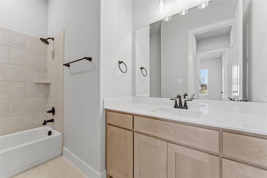 Full bath with tub / shower combination, vanity, and light tile patterned floors