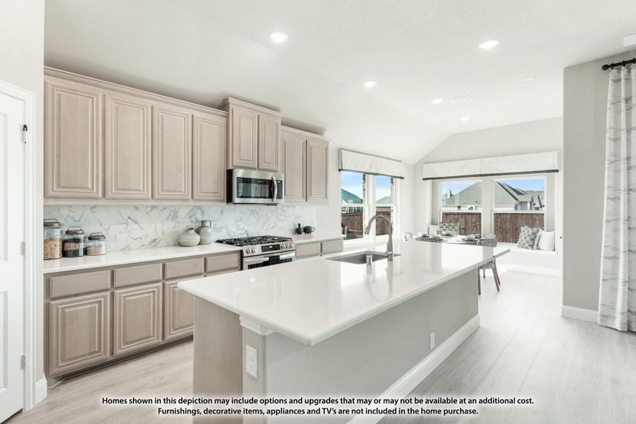 Kitchen with light gray cabinets, marble backsplash, center island with sink, and stainless steel appliances Kitchen with light gray cabinets, marble backsplash, center island with sink, and stainless steel appliances