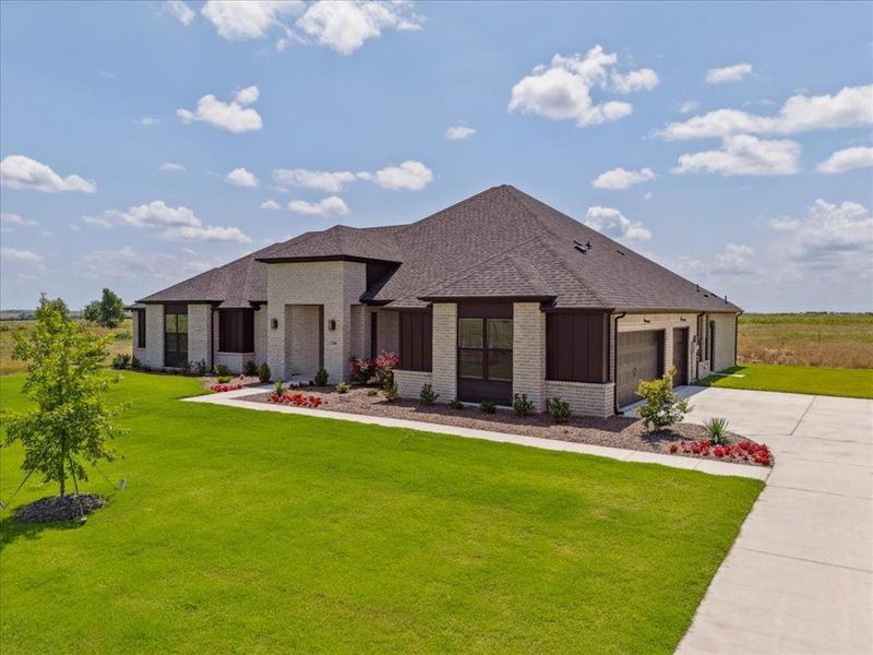 Front exterior of a new home in Coppenger Place, Godley, TX, highlighting curb appeal (Image 26). Front exterior of a new home in Coppenger Place, Godley, TX, highlighting curb appeal (Image 26).