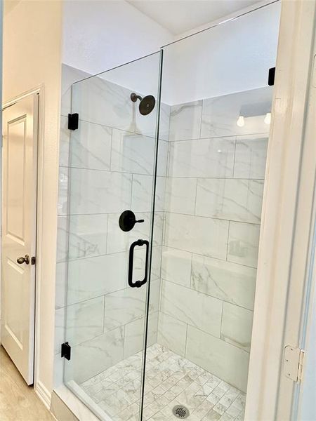Full bathroom featuring a stall shower