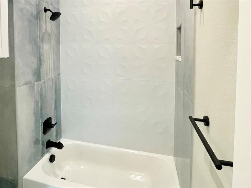 Jack and Jill bath has separate shower toilet divided from dual sinks with a pocket door.