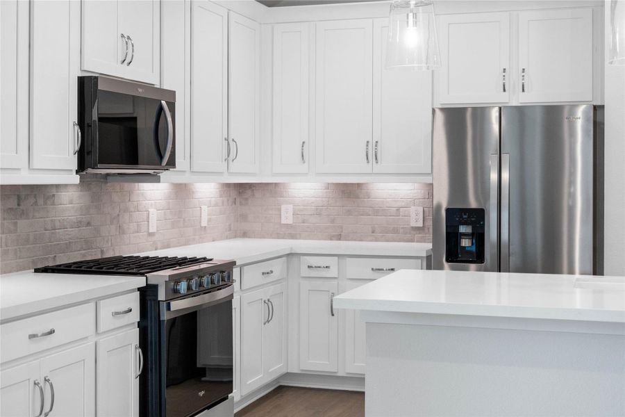 Welcome to the heart of the home, a modern, highly functional kitchen that perfectly balances style and utility. Quartz countertops, complemented by a stylish backsplash, cabinets that provide ample storage, under cabinet lighting and the Whirlpool stainless steel appliances are all features of this beautiful kitchen!