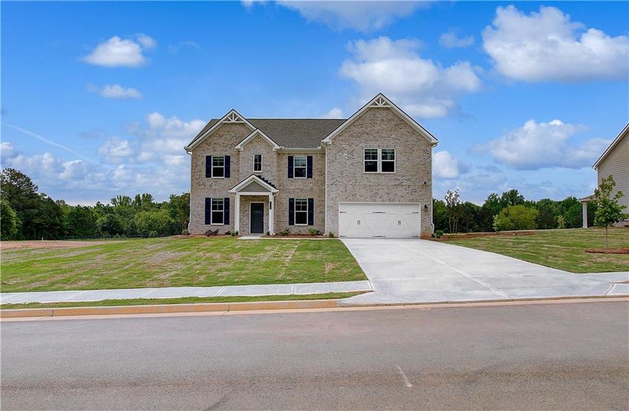 Front exterior of a new home in Copperfield, Locust Grove, GA, highlighting curb appeal (Image 2).