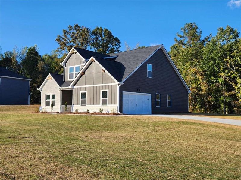 Front exterior of a new home in The Woodlands Preserve, Jackson, GA, highlighting curb appeal (Image 17).