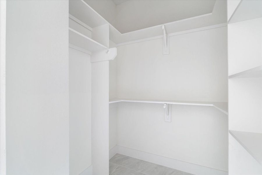 A spacious walk in closet complete with custom shelving & ample storage! A spacious walk in closet complete with custom shelving & ample storage!