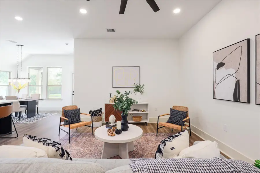 Living room featuring wood finished floors, recessed lighting, and ceiling fan