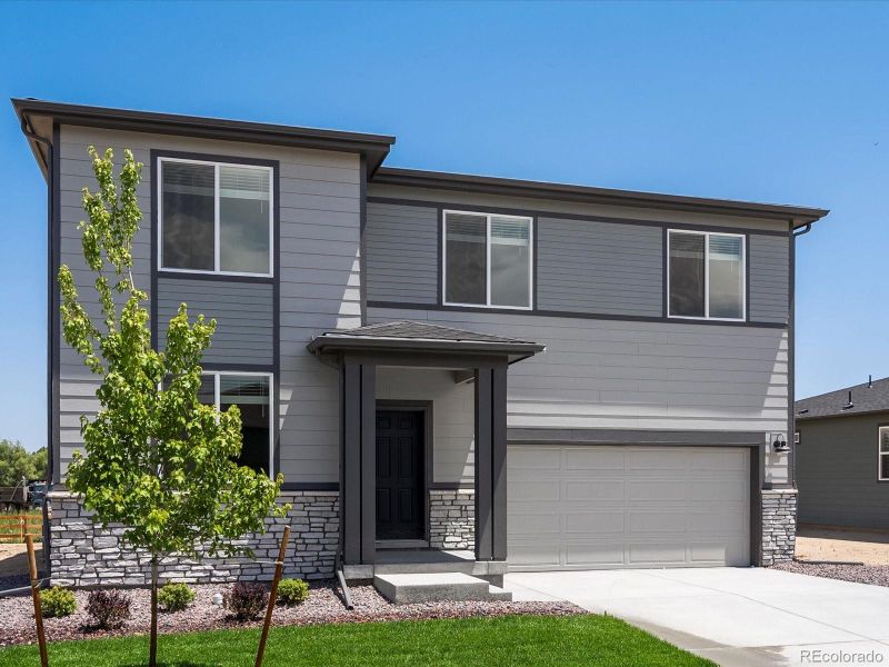 Front exterior of a new home in Poudre Heights: The Lakes Collection, Windsor, CO, highlighting curb appeal (Image 2).