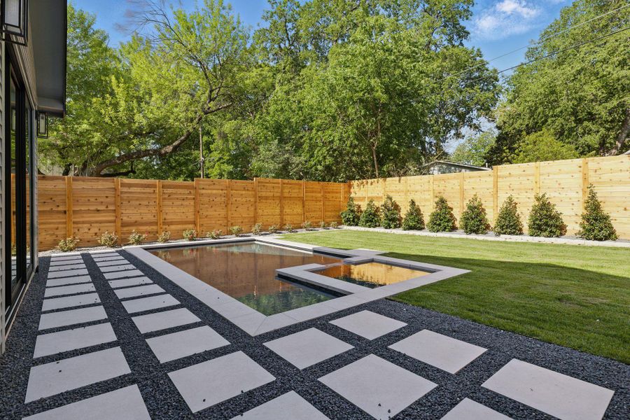 Fenced backyard with a patio area