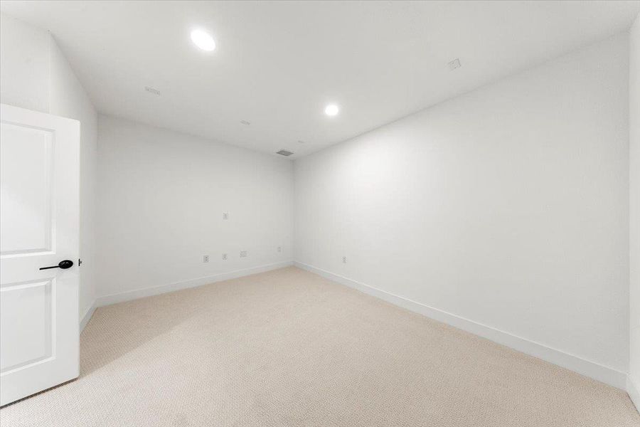 Empty room featuring light colored carpet and recessed lighting Empty room featuring light colored carpet and recessed lighting
