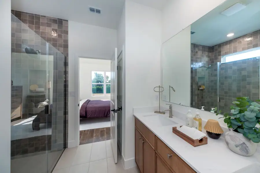 A spa-inspired primary bathroom with dual sinks, a spacious shower, and thoughtfully selected finishes for everyday comfort and luxury. A spa-inspired primary bathroom with dual sinks, a spacious shower, and thoughtfully selected finishes for everyday comfort and luxury.