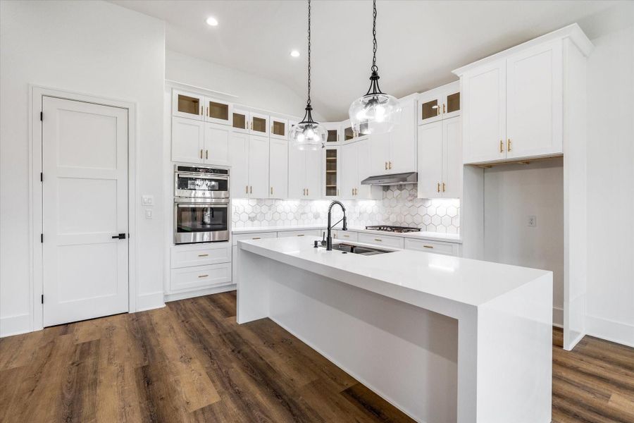 Experience the beauty of a bright and airy island kitchen, complete with a stunning quartz waterfall countertop and convenient self-closing cabinet drawers and doors. Experience the beauty of a bright and airy island kitchen, complete with a stunning quartz waterfall countertop and convenient self-closing cabinet drawers and doors.