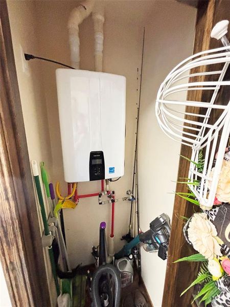 Utility room featuring water heater Utility room featuring water heater