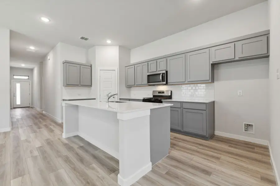 Kitchen in the Quartz home plan by Trophy Signature Homes – REPRESENTATIVE PHOTO