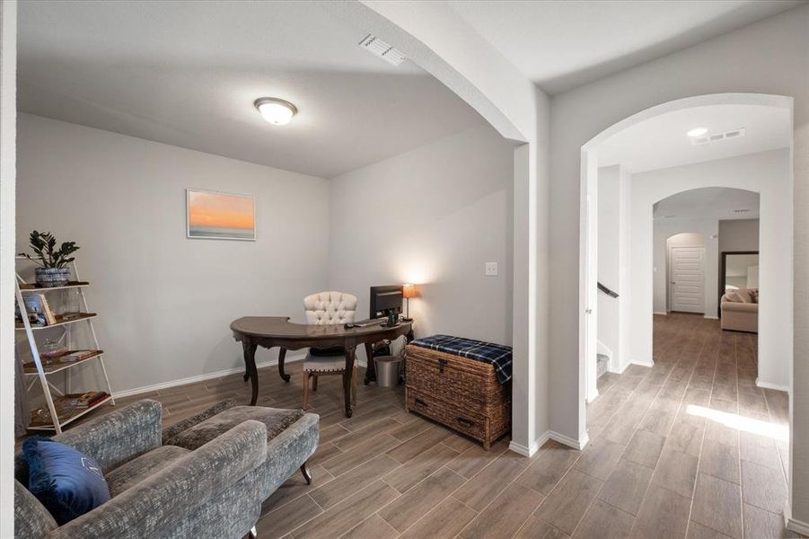 Office area with hardwood / wood-style flooring