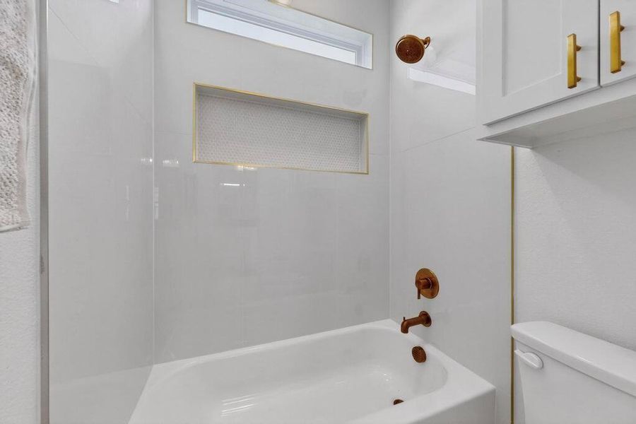 Bathroom with toilet and bathtub / shower combination
