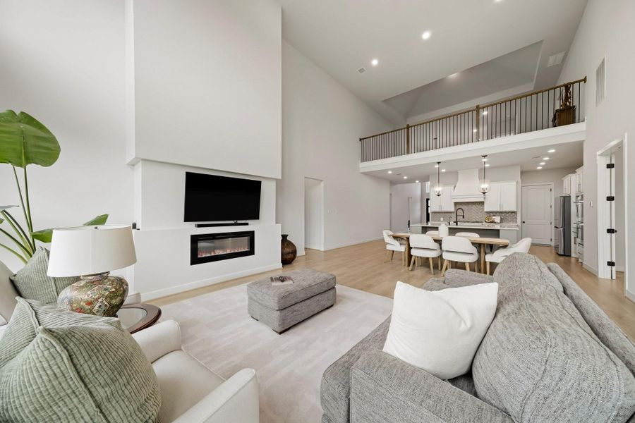The expansive family room exudes a refined, welcoming ambiance, with generous proportions and a seamless connection to the dining area and kitchen. Designed for both elevated entertaining and relaxed everyday living, the open-concept layout creates a polished sense of flow while keeping conversation effortless and guests comfortably connected throughout the space.