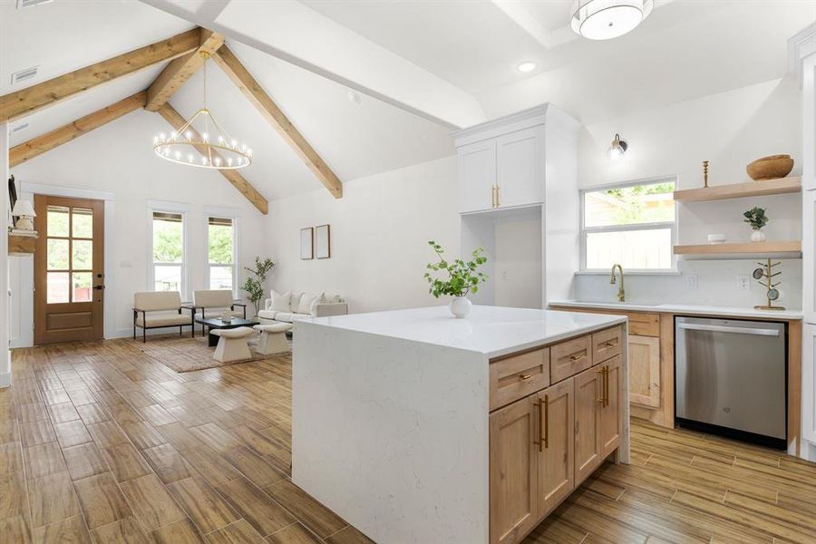 Kitchen featuring light hardwood / wood-style floors, dishwasher, beam ceiling, and a center island