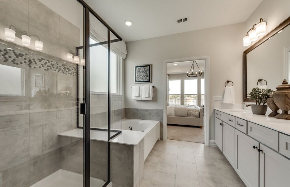 Spacious owner's bath with tile flooring and large