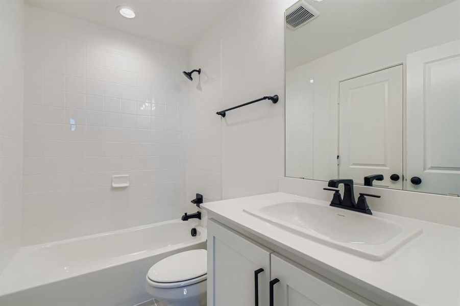 Full bathroom featuring vanity, shower / bathtub combination, and recessed lighting