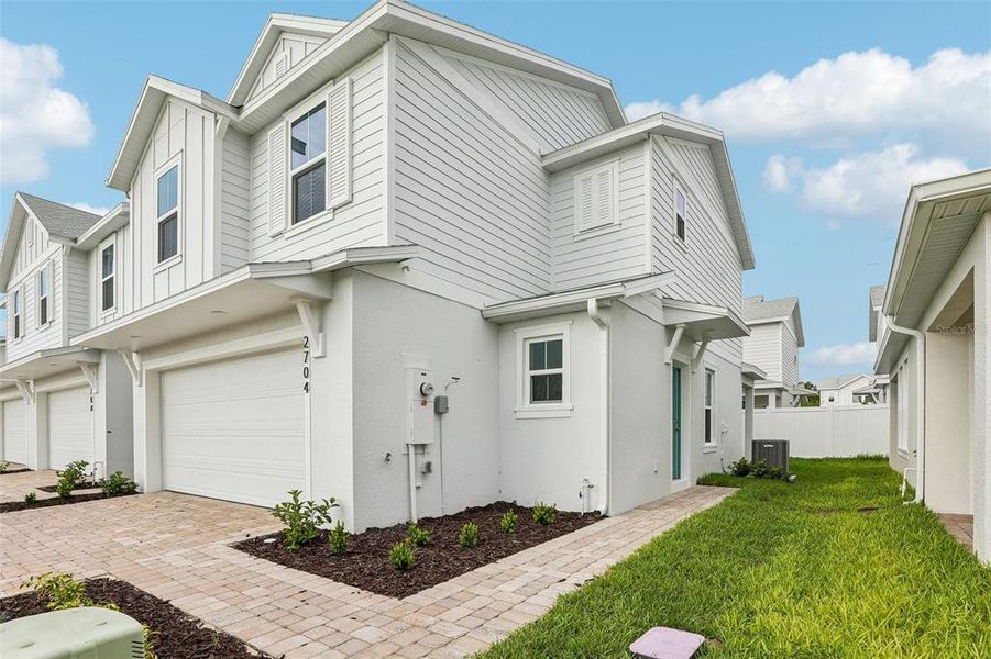 Front exterior of a new home in Cyrene at Harmony, St. Cloud, FL, highlighting curb appeal (Image 23). Front exterior of a new home in Cyrene at Harmony, St. Cloud, FL, highlighting curb appeal (Image 23).