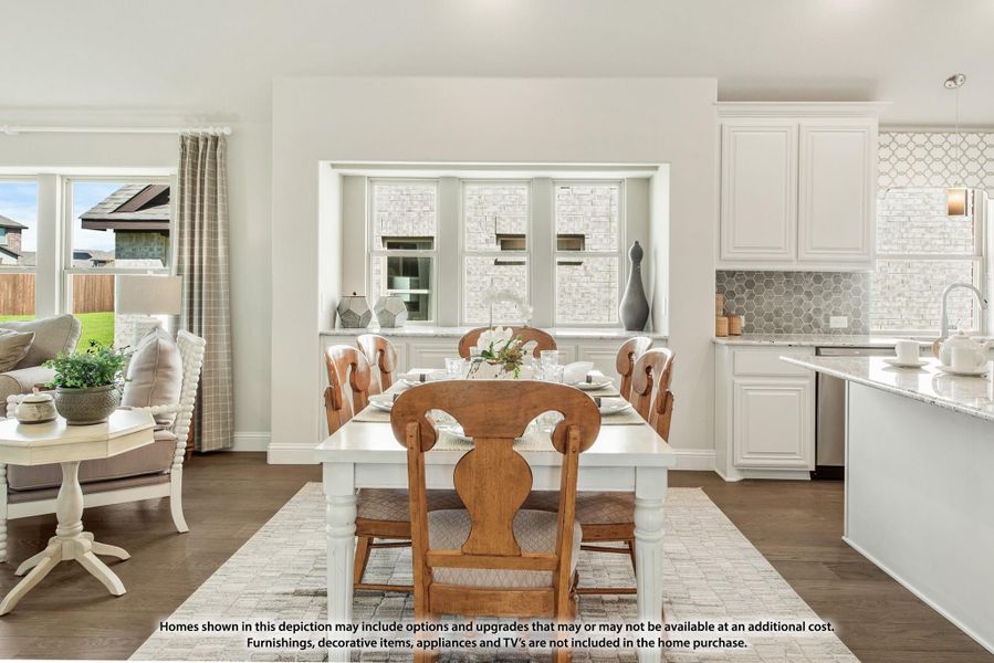 Dining area with white table and wood chairs, open to kitchen with white cabinets and tile backsplash Dining area with white table and wood chairs, open to kitchen with white cabinets and tile backsplash