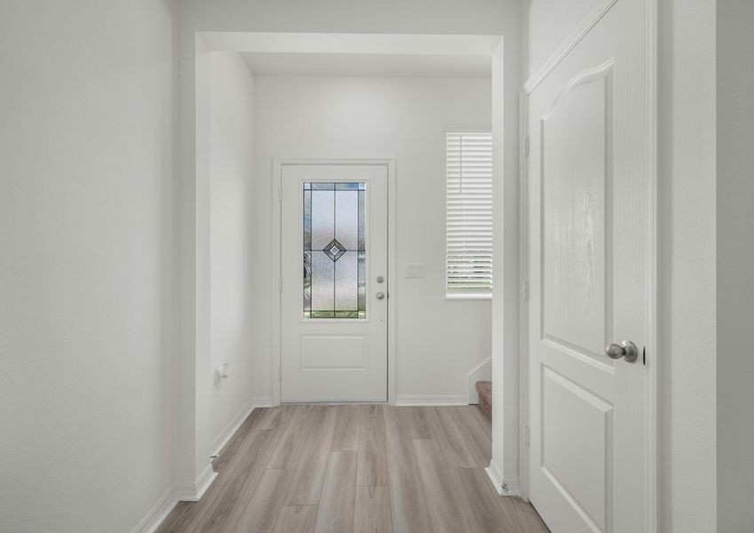 The foyer includes this gorgeous 3/4 lite door!