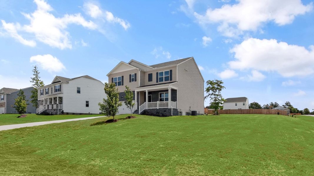 Front exterior of a new home in Mason Ridge, Spring Lake, NC, highlighting curb appeal (Image 2). Front exterior of a new home in Mason Ridge, Spring Lake, NC, highlighting curb appeal (Image 2).