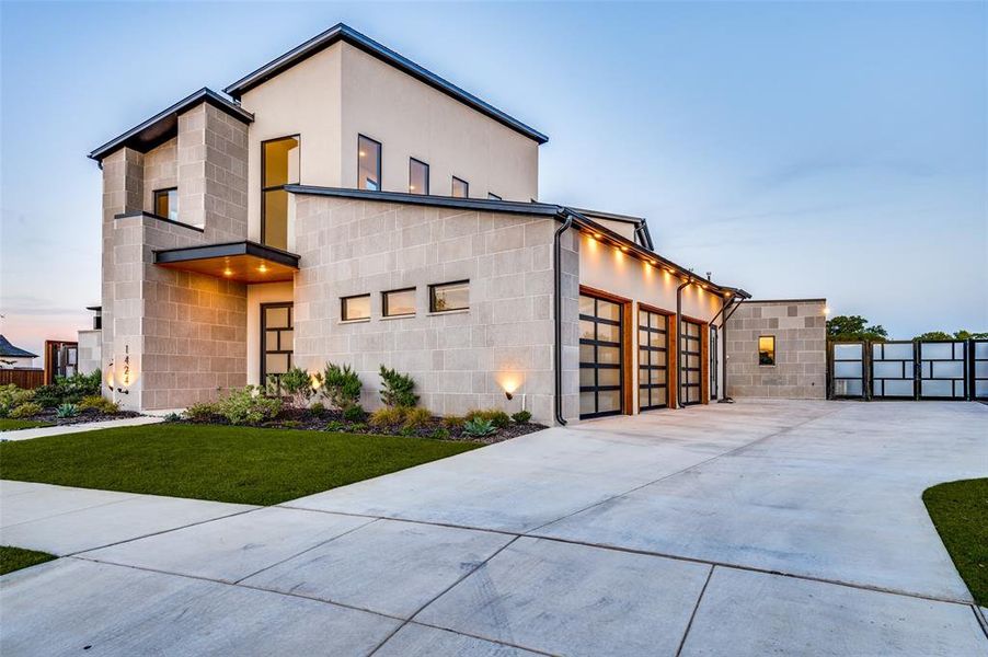 Modern home featuring a lawn and a garage