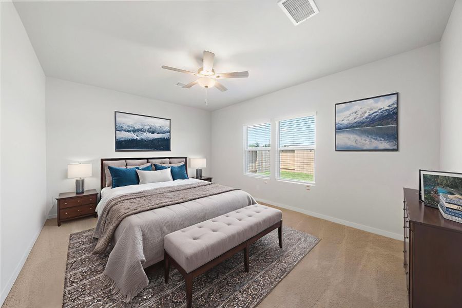 A bedroom with a bed and a bench.