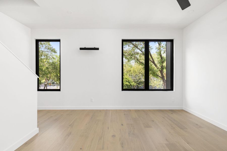 Spare room featuring light wood-style flooring and ceiling fan
