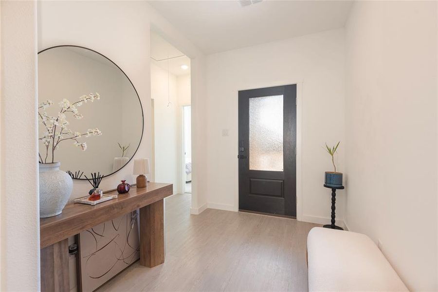 Entrance foyer with light wood finished floors and baseboards Entrance foyer with light wood finished floors and baseboards