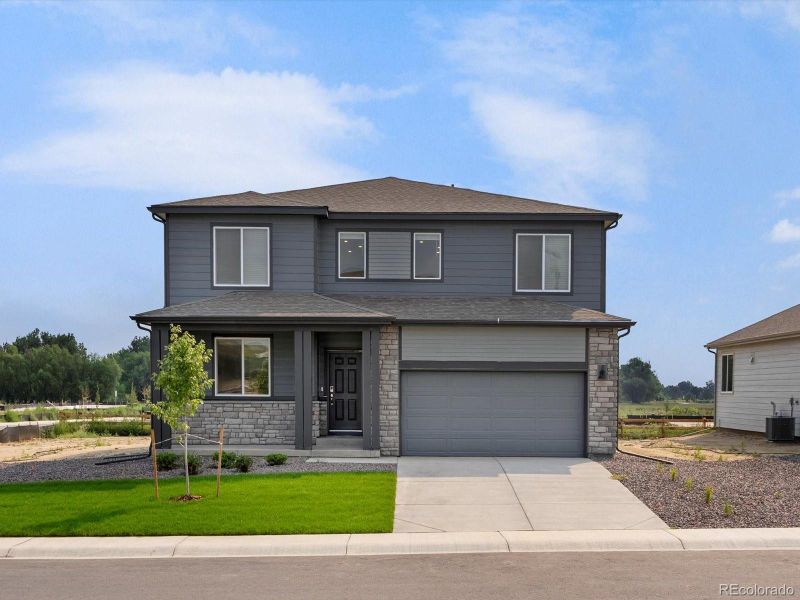 Front exterior of a new home in Poudre Heights: The Lakes Collection, Windsor, CO, highlighting curb appeal (Image 2).