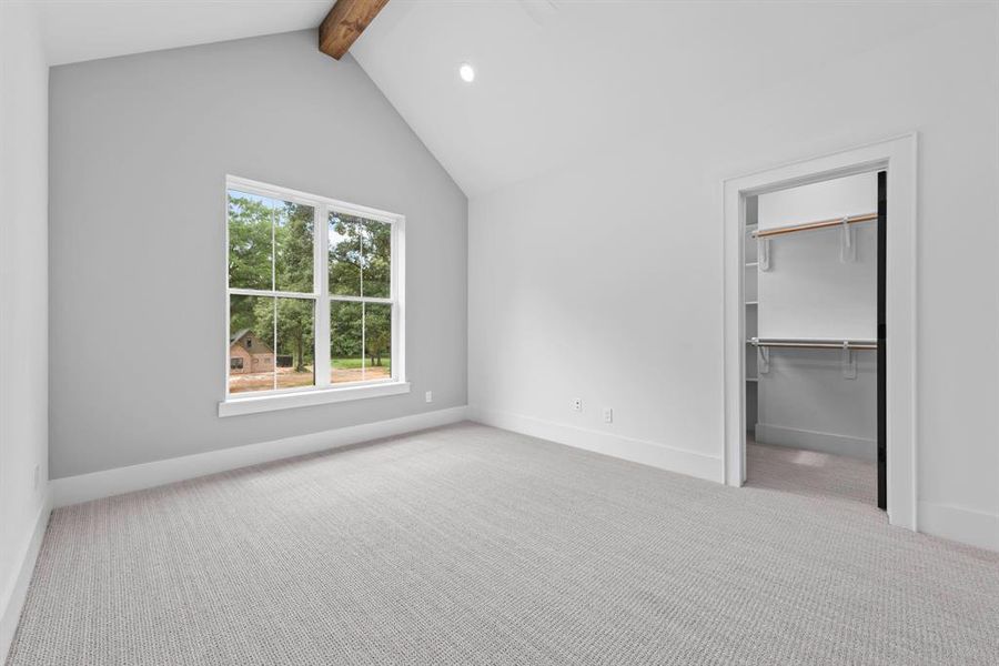 1st secondary bedroom upstairs with large walk in closet and window. Cathedral ceiling and stained beam.