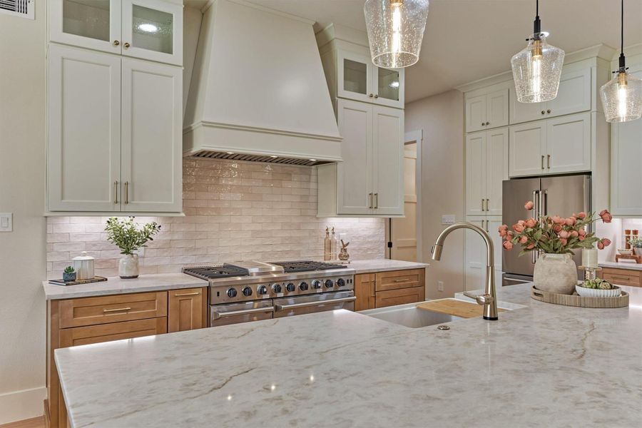 A closer look at the details that make this kitchen special: dramatic Taj Mahal quartz with natural movement throughout, a deep apron-front farmhouse sink with pull-down gooseneck faucet, and that commercial-style range ready for anything from Sunday pancakes to holiday hosting. Every finish here was chosen on purpose. A closer look at the details that make this kitchen special: dramatic Taj Mahal quartz with natural movement throughout, a deep apron-front farmhouse sink with pull-down gooseneck faucet, and that commercial-style range ready for anything from Sunday pancakes to holiday hosting. Every finish here was chosen on purpose.