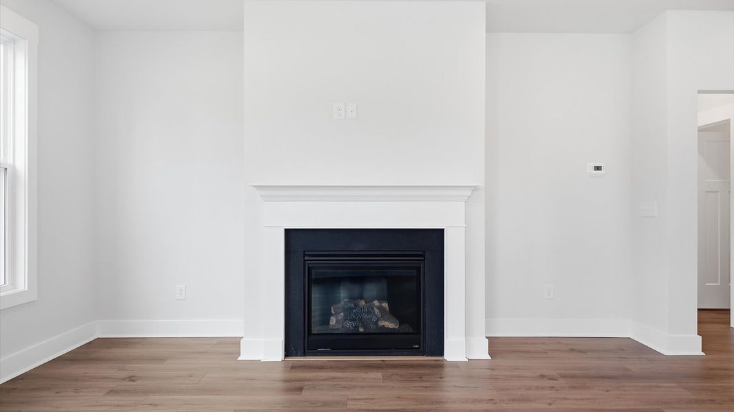 Memorable moments begin in this elegant, open family room with hardwood flooring and refined finishes in Anderson, SC