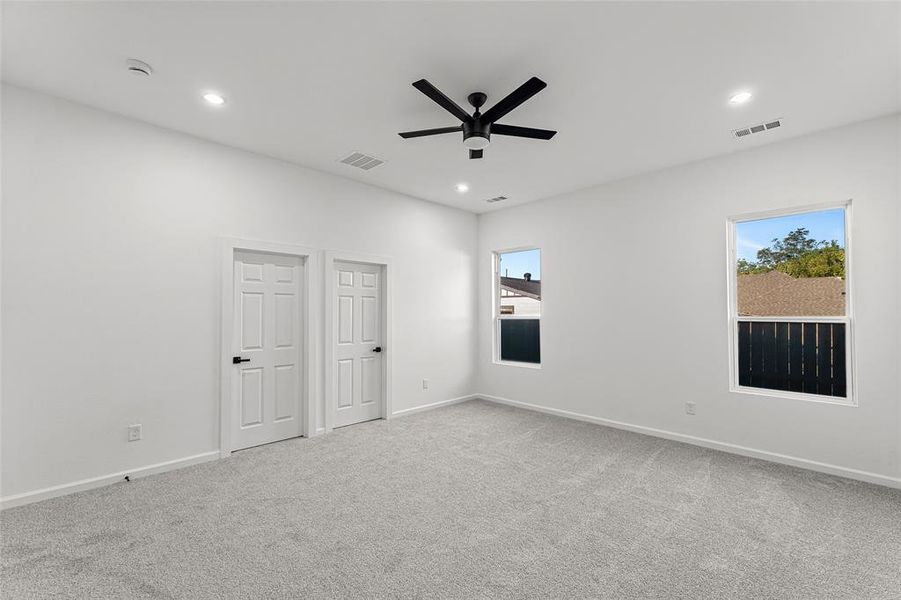 Spare room featuring light carpet, recessed lighting, and ceiling fan
