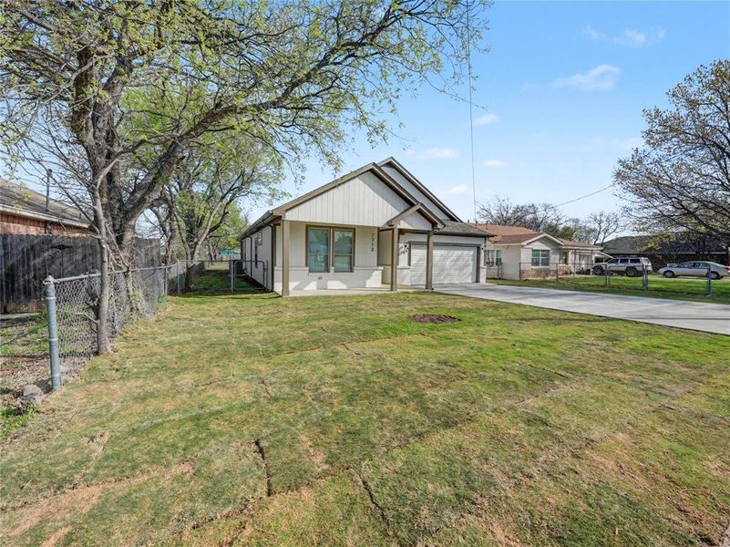 View of front of property with driveway and an attached garage