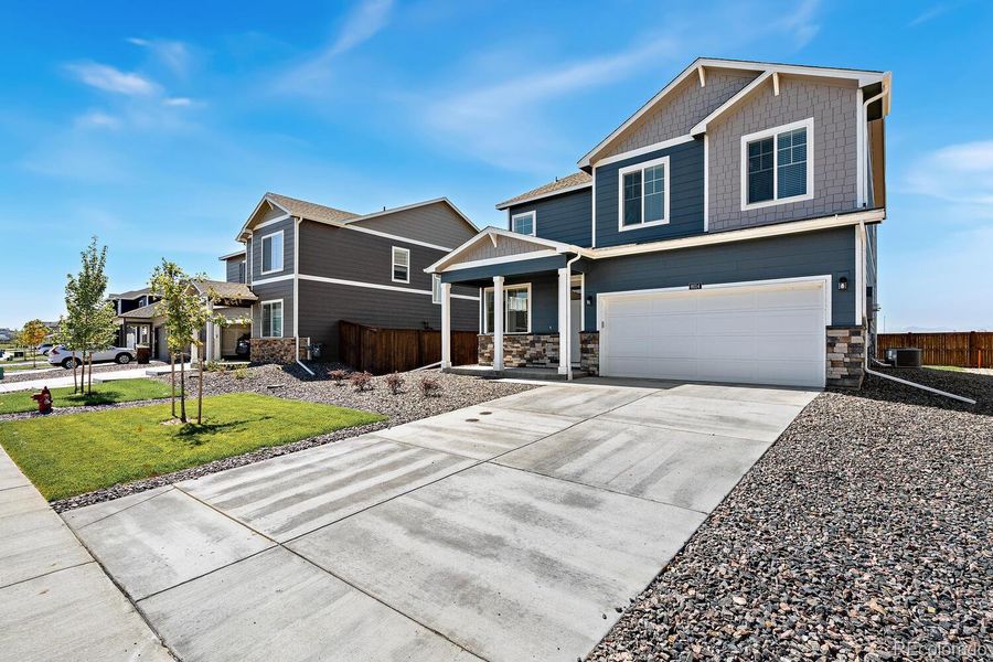 Front exterior of a new home in Silver Peaks, Lochbuie, CO, highlighting curb appeal (Image 2). Front exterior of a new home in Silver Peaks, Lochbuie, CO, highlighting curb appeal (Image 2).