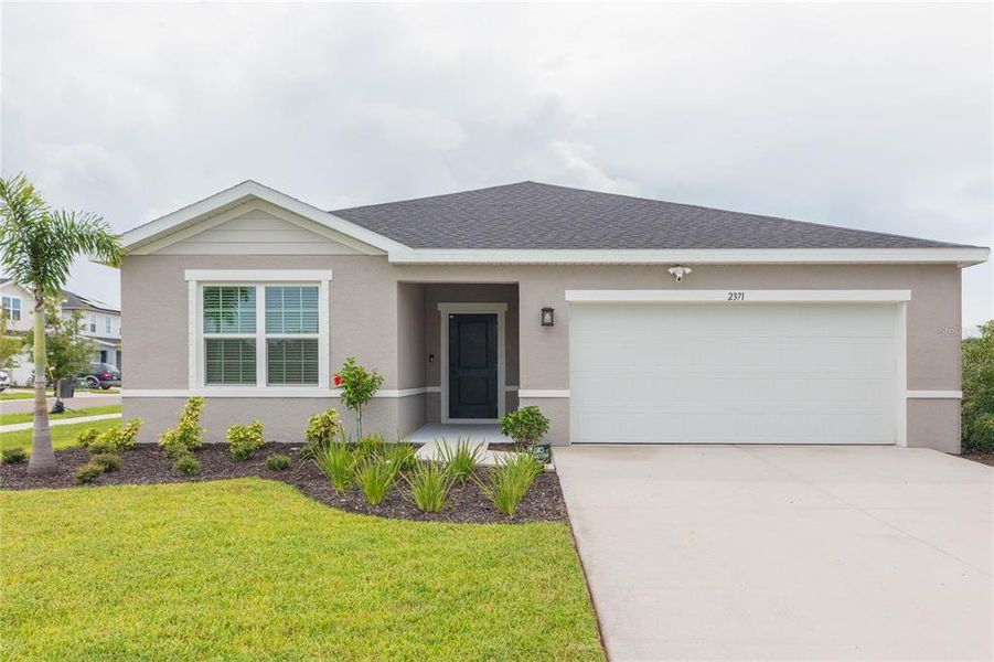 Front exterior of a new home in Cypress Ridge Ranch, Wimauma, FL, highlighting curb appeal (Image 2). Front exterior of a new home in Cypress Ridge Ranch, Wimauma, FL, highlighting curb appeal (Image 2).