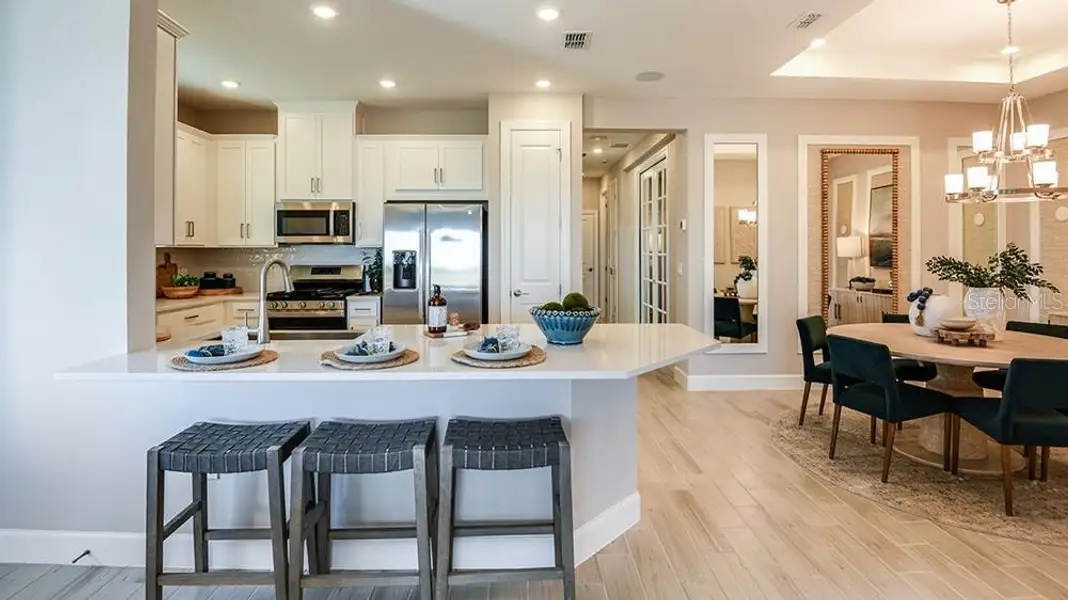 Furnished interior view inside a new home in Esplanade at McKinnon Groves, Winter Garden (Image 8).