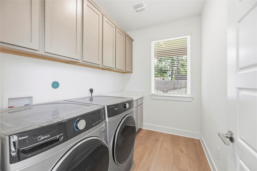 Sizable utility room off the kitchen includes with extra storage.