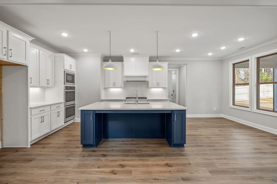 The kitchen featues a large center island overlooking the breakfast area