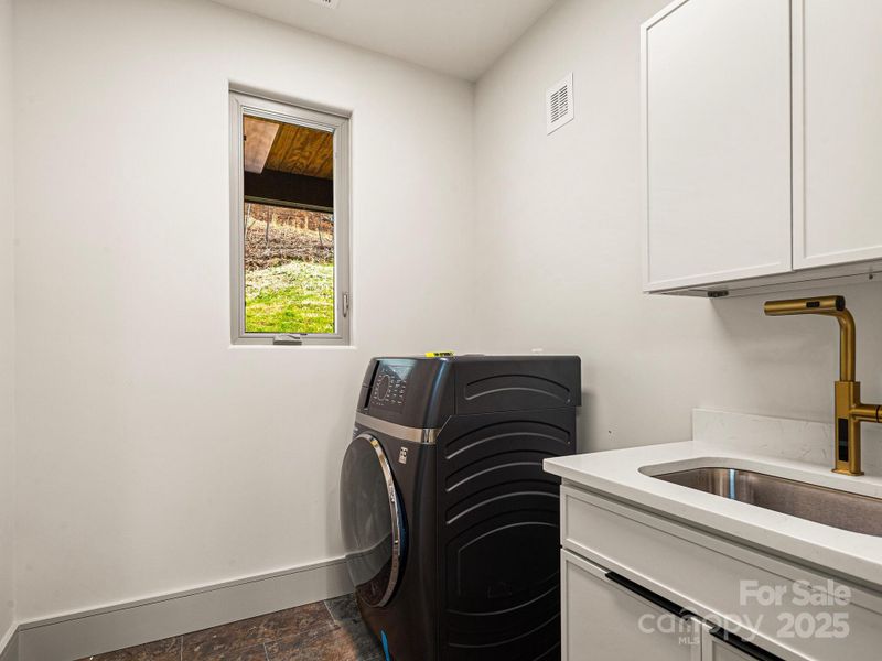 Laundry with sink and storage