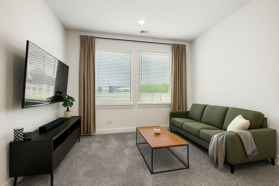 This spacious game room sits just off the main living area and features plush carpet, recessed lighting, and large windows—perfect for movie nights, game days, or just hanging out. Let the good times begin! *This photo has been virtually staged This spacious game room sits just off the main living area and features plush carpet, recessed lighting, and large windows—perfect for movie nights, game days, or just hanging out. Let the good times begin! *This photo has been virtually staged