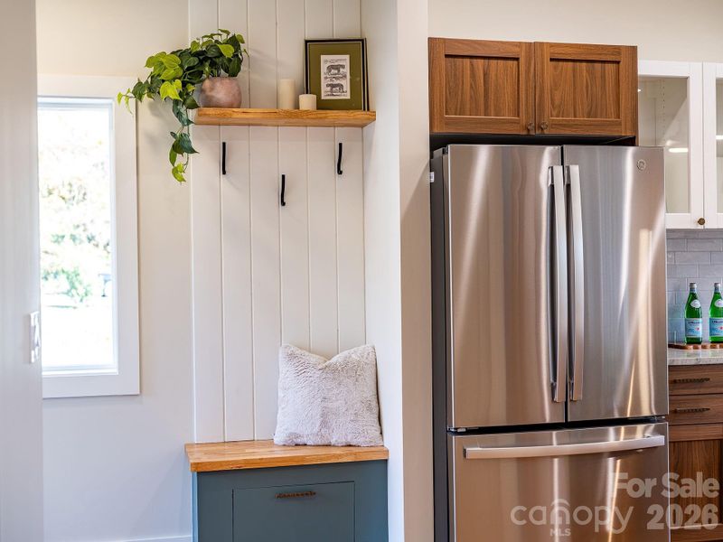 Built in shoe cabinet with hooks in entry foyer