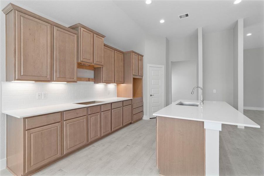 This kitchen is by far any chef’s dream! This spacious kitchen features high ceilings, stained wood cabinets, quartz countertops, SS appliances, modern tile backsplash, recessed lighting, quartz kitchen island with space for breakfast bar, and a walk-in pantry all overlooking your huge family room.