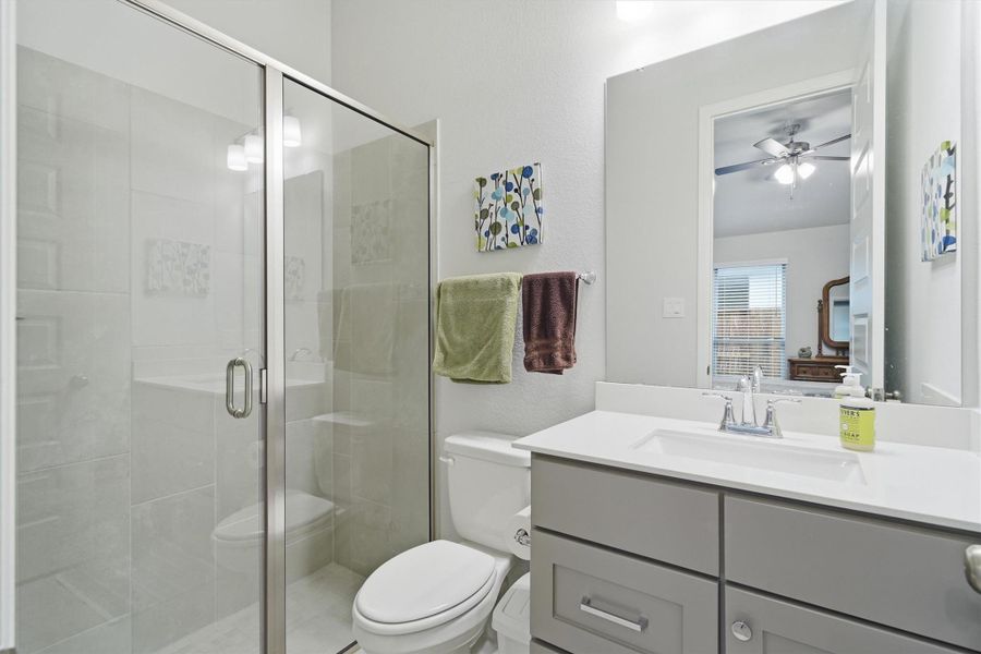 En suite off the secondary bedroom with fully tiled stand alone shower En suite off the secondary bedroom with fully tiled stand alone shower