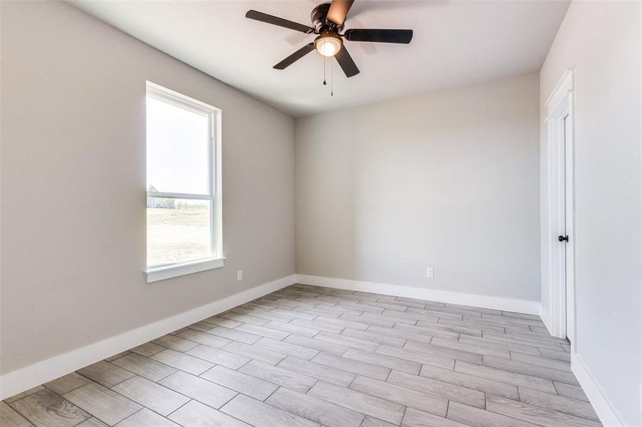 Spare room featuring light hardwood / wood-style floors and ceiling fan