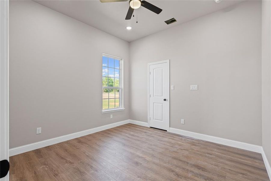 Unfurnished room with wood finished floors, ceiling fan, baseboards, and recessed lighting